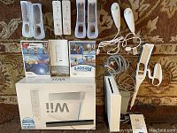 Full set includes Wii console, two Wii remotes with straps, two sets of silicone covers, sensor bar, power and AV cables, and two Wii game cases.