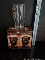 Two boxed Guinness glasses with Halloween themed packaging and harp logo on glass.