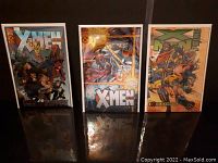 Three Marvel X-Men comic books standing upright showing covers