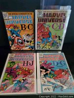 Four Marvel Universe Handbook comic books arranged in protective sleeves. Front covers feature colorful illustrations of various Marvel characters. Comics cover alphabetical character ranges B-C, C-D, H-J, and D-G.