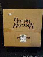 Cardboard box labeled Golem Arcana indicating original packaging.
