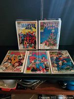 Five Marvel Age comics displayed in protective sleeves including holiday and superhero themes.