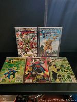 Group photo showing 5 Superman comic books arranged on a surface with colorful cover art depicting various scenes and characters.