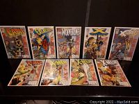 Nine Marvel comic books arranged in two rows on a dark surface including titles Cable, Excalibur, Wolverine, X-Men, and X-Force.