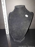 Front view of black velvet necklace display stand with measuring ruler showing height about 10 inches.