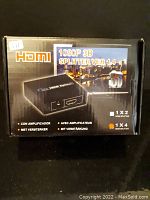 Front view of the HDMI splitter box showing model and features on packaging