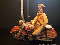 Front view of the hand-painted police motorcycle statue with officer figure on bike.