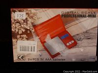 Photo of the digital scale Professional-Mini in original box, showing the product image and labeling.