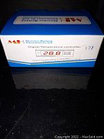 Front view of blue and white box showing digital temperature controller product image and branding by Shenzhen Meihang Electronic Co. Ltd.