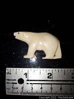 Front view of the polar bear shaped pin with ruler showing size approximately 2.25 inches