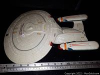 Top-down view of the U.S.S. Enterprise model with ruler for scale.