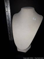 Front view of white velvet necklace stand with a ruler for scale showing height around 10 inches.