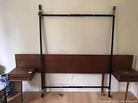 Full view of headboard, attached nightstands and metal frame.