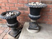 Both urn planters side by side with rocks and bases