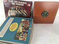 Photo showing front view of two vinyl LP album covers 'H.M. Life Guards On Parade' and 'Those Memory Years' with a brown cover LP to the right.