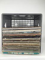 Stack of assorted vinyl LP records showing varied titles and artists, viewed from side for spine identification