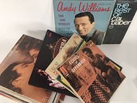 Photo showing a collection of various vintage vinyl LP records including Andy Williams and Cal Tjader albums.