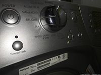 Close up photo of washer control panel showing multiple wash cycle options and TumbleFresh feature.