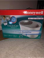 Front of Honeywell Cool Moisture Humidifier box showing product image, easy top fill design, and key features.