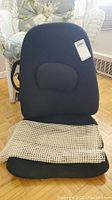 Front view of black ObusForm backrest with lumbar cushion and attached beige mesh seat cover.