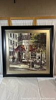 Front view of the framed print 'The Crepe House' showing a street scene with cafe tables and a bicycle.