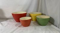 Set of four colorful Crate & Barrel Addison ceramic mixing bowls arranged in descending size order