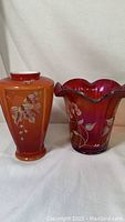 Front view of orange and red vases side by side
