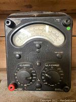 Front view of vintage Universal Avometer multimeter with large analog dial and rotary range selectors