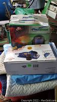 Boxed ProStar automatic darkening welding helmet seen behind Drill Doctor tool box, boxed and new condition unclear.