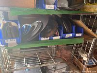 Shelf with blue bins holding cutoff wheels and grinding wheels in various sizes and thicknesses.