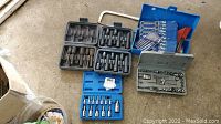 Overview photo showing multiple tool sets in cases including socket bits, precision screwdriver bits, wrenches, and drill bits.