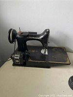 Side view of the Singer sewing machine showing motor and spool pin