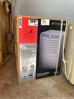 Zenith Z009 dehumidifier in unopened box showing front panel image and product details.