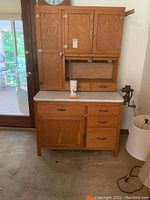 Full front view of Hoosier-style cabinet showing upper and lower sections and enamel countertop