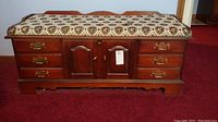 Full front view of Lane cedar chest showing wood finish and tapestry fabric seat with floral medallion pattern.