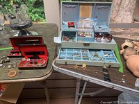 Two jewelry boxes on table with assorted jewelry