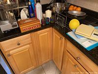 Photo showing kitchen counter with various kitchen items including a kitchen scale, travel drink bottles, candles, and mixing bowls.