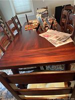 Full set of table and eight chairs arranged in dining room