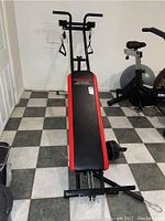 Full angled view of the Weider Ultimate Bodyworks cable workout system showing the padded bench and frame structure.