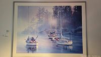 Framed artwork showing boats in water with pine trees and misty background.