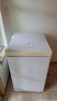 Front view of the white Danby chest freezer with lid closed, showing compact size and clean exterior.