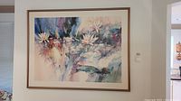 Framed floral watercolor art print hanging on wall showing full front view with clear details of flowers and colors.