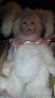 Marie Osmond Velveteen Rabbit doll in white velveteen costume with porcelain-like face and blue eyes inside original box.