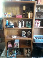 Front view of the wooden bookcase showing multiple shelves with various items, which are not included.