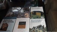 Overview photo of seven architectural and CADD textbooks laid out on a table with visible titles and cover images featuring residential and commercial buildings.