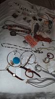 Wide view of the costume jewelry assortment showing various items spread out on a surface.