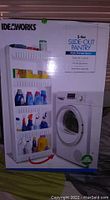 Box photo showing 5-tier slide-out pantry filled with laundry products next to a front-loading washing machine.
