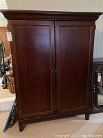 Front view of closed large mission style computer cabinet with two doors and tapered legs.