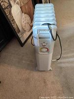 Full side view of white Lakewood electric heater showing fins and top handle with looped power cord