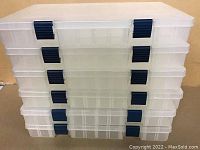Stacked view of the six Plano storage cases showing the clear plastic outer shell and blue latches on front.
